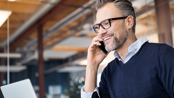 A businessman is talking over phone; image used for HSBC Sri Lanka Telephone Banking landing page