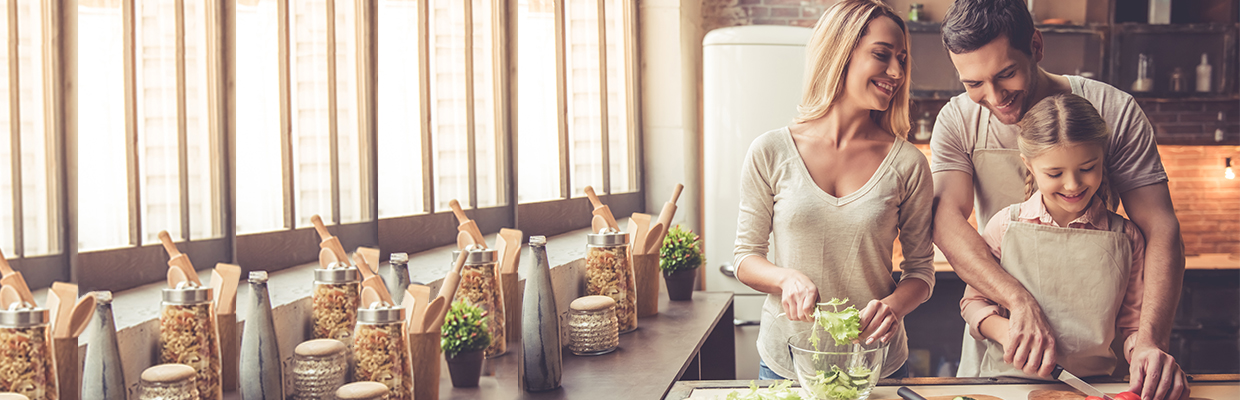 a happy family of three cooking together; image used for HSBC Sri Lanka Credit Cards Rewards